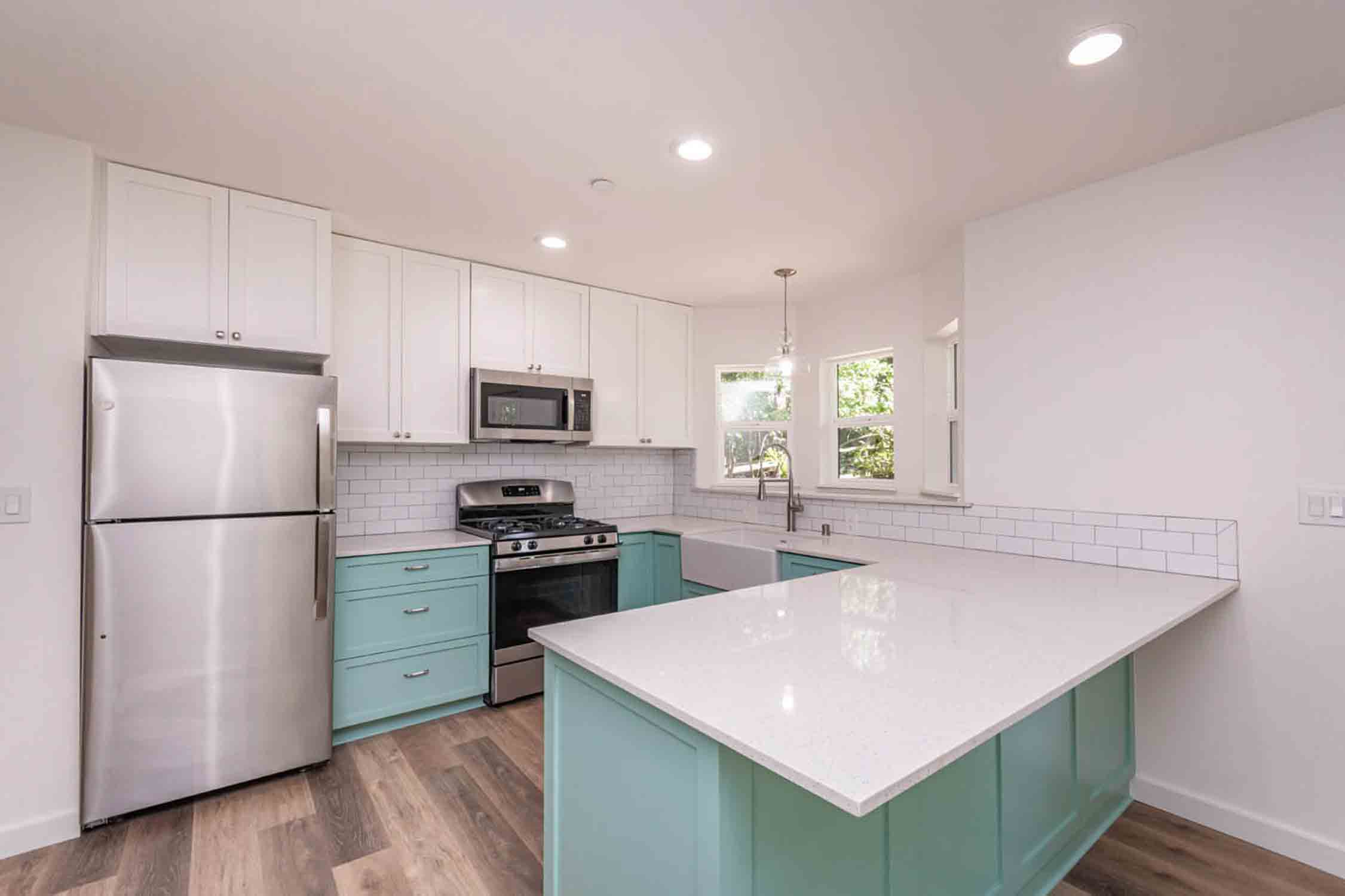 ADU you home built on a California home property with a white kitchen and green cabinets.