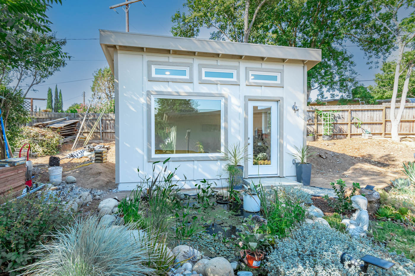 A Denver detached ADU in a California backyard by a pool, learn more about our best tiny home builder in Denver.