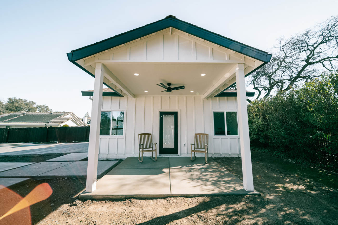 Anchored Tiny Homes Jacksonville in front of a white ADU, done by our garage contractor in Jacksonville, FL.