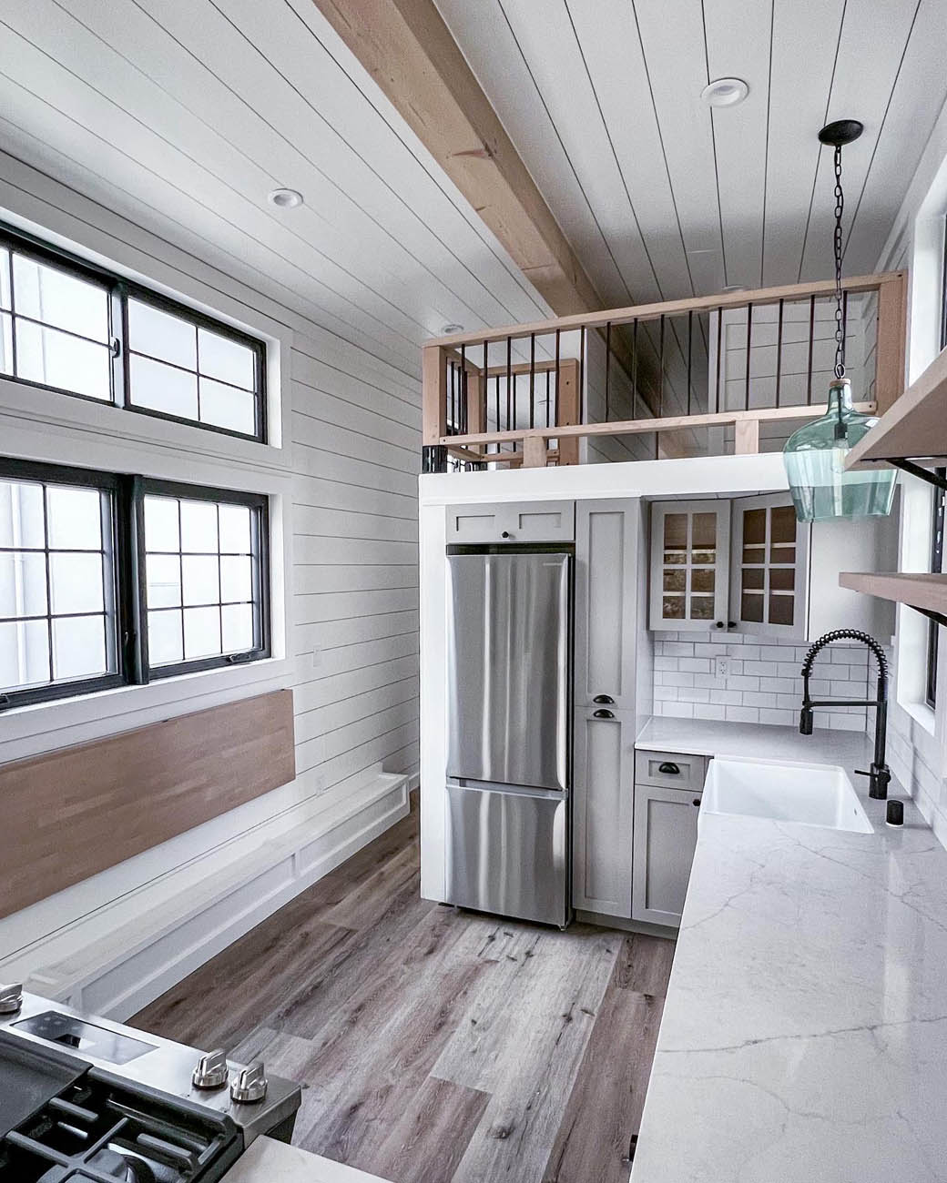 Inside a tiny ADU kitchen with a bedding loft, provided by Anchored Tiny Homes custom small home builder in Oklahoma City.