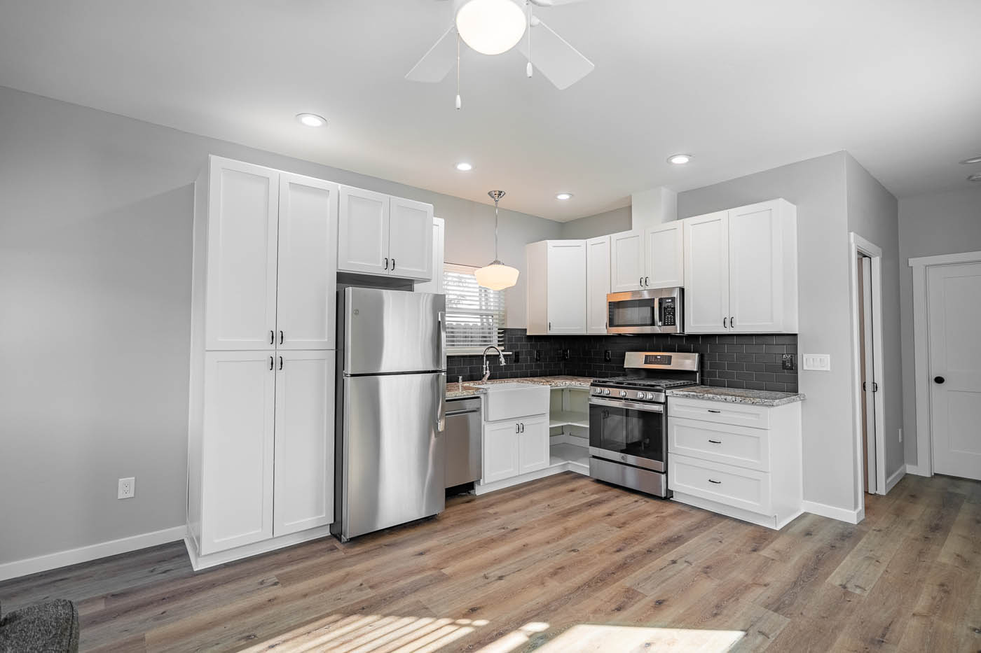 A beautiful white kitchen in an ADU home, contact our tiny house company today.